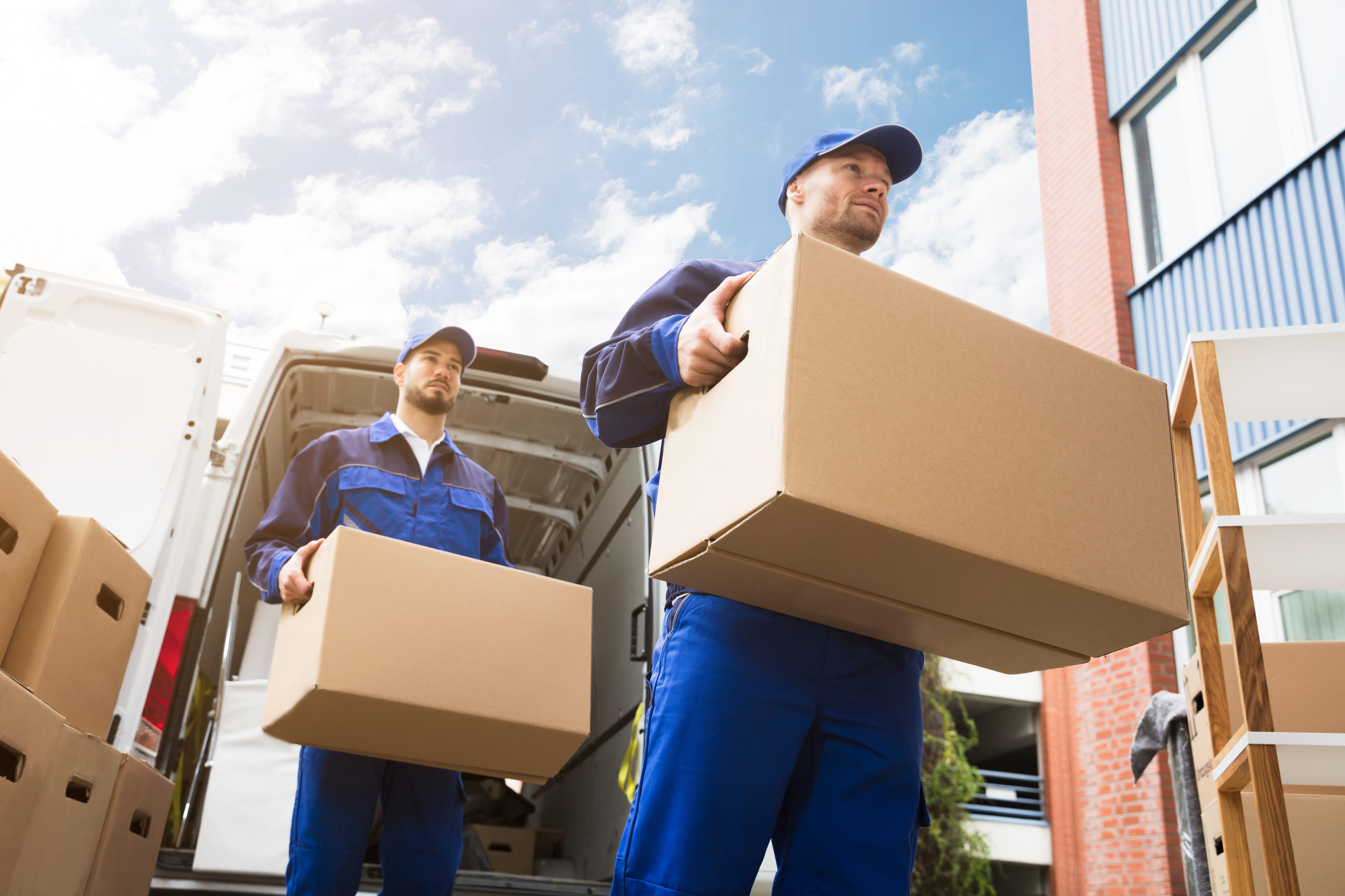 delivery men taking large packages from a truck